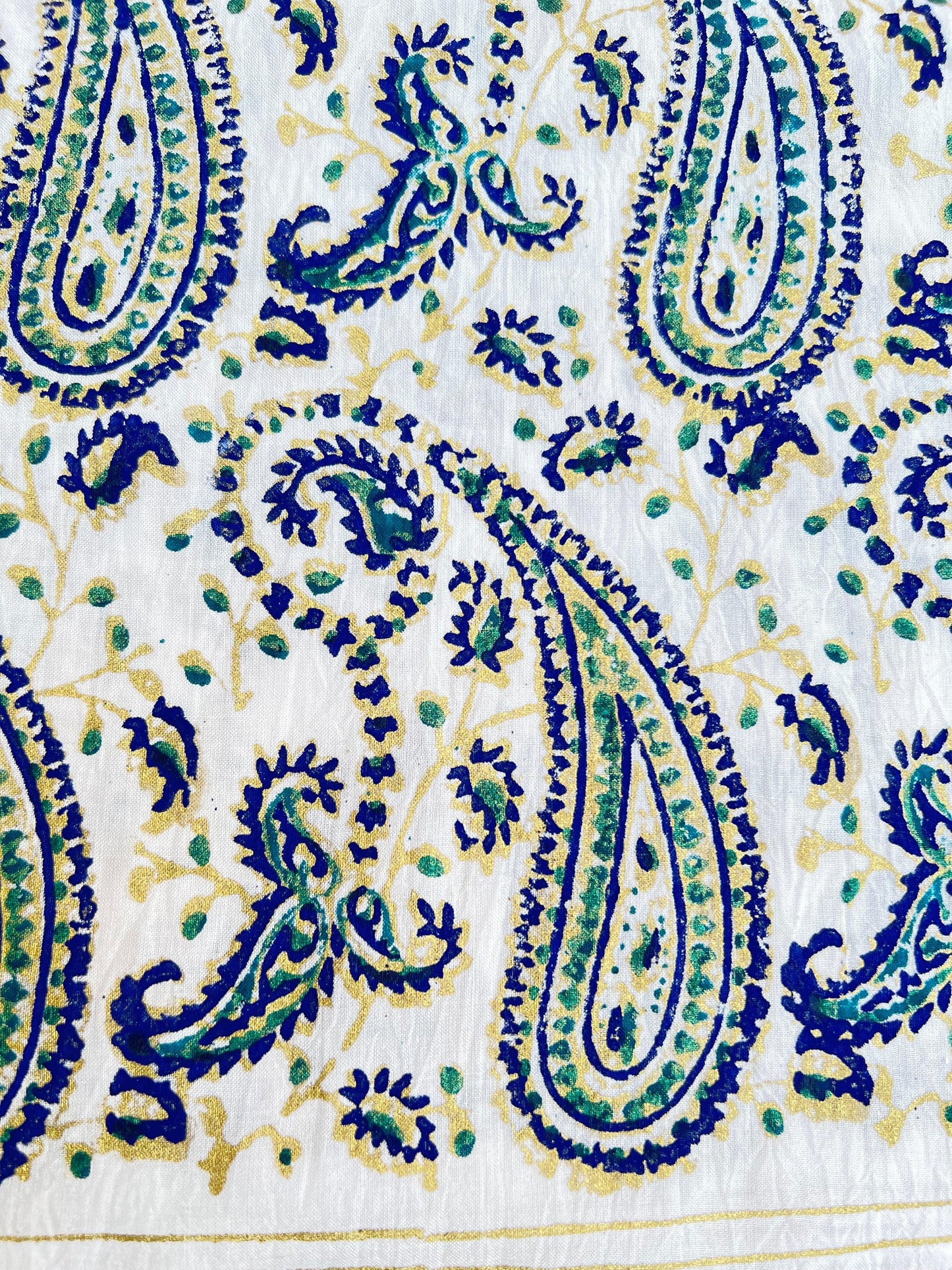 This gold and blue paisley design adds an elegant touch to our kora white fabric.